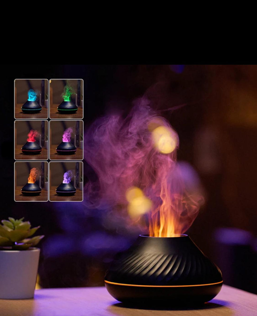 An elegant black diffuser sits on the table with a subtle LED light around the body, emitting puffs of scented smoke in the air. The top left corner has a panel that displays the LED Color variations.