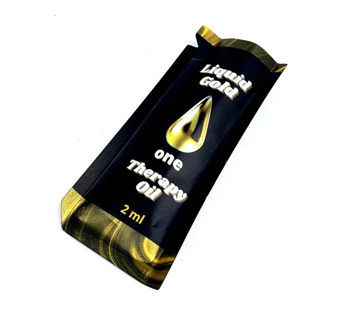 A small 2ml packet of Liquid Gold One Therapy Oil (angled shot)